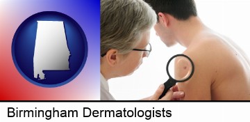a dermatologist examines a mole on a male patient in Birmingham, AL