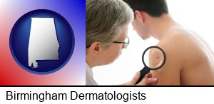 Birmingham, Alabama - a dermatologist examines a mole on a male patient