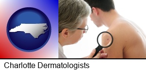 Charlotte, North Carolina - a dermatologist examines a mole on a male patient