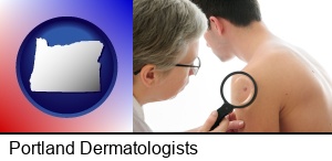 Portland, Oregon - a dermatologist examines a mole on a male patient