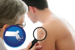 massachusetts map icon and a dermatologist examines a mole on a male patient
