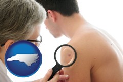 north-carolina map icon and a dermatologist examines a mole on a male patient