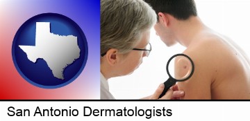 a dermatologist examines a mole on a male patient in San Antonio, TX